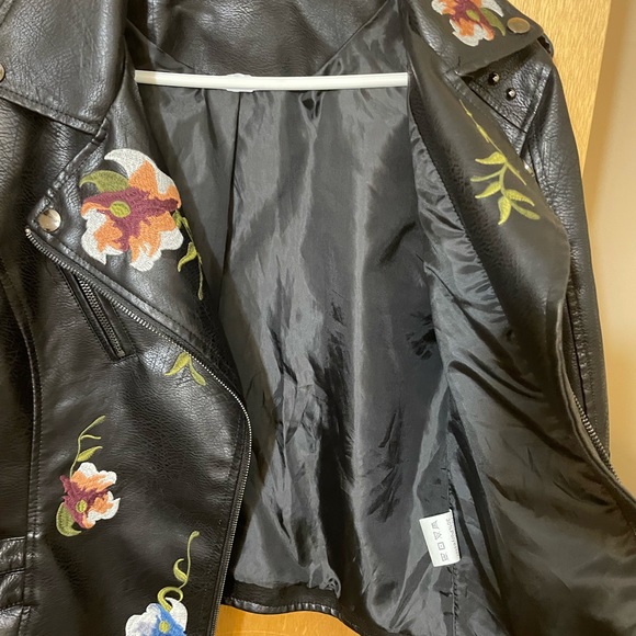 Floral embroidery, stud accents, buckles on side, faux leather, zipper on arms. - Picture 7 of 8